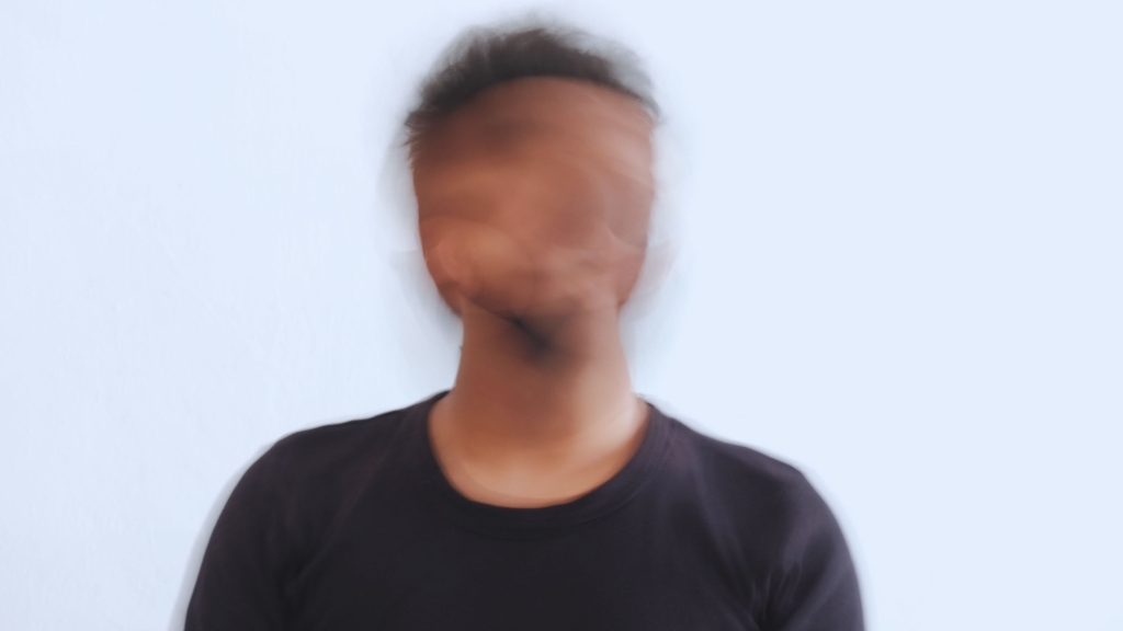 Blurred face of man wearing black shirt
